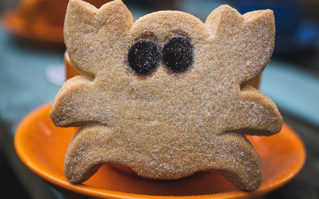 A picture of a scared looking cookie in the shape of a crab.